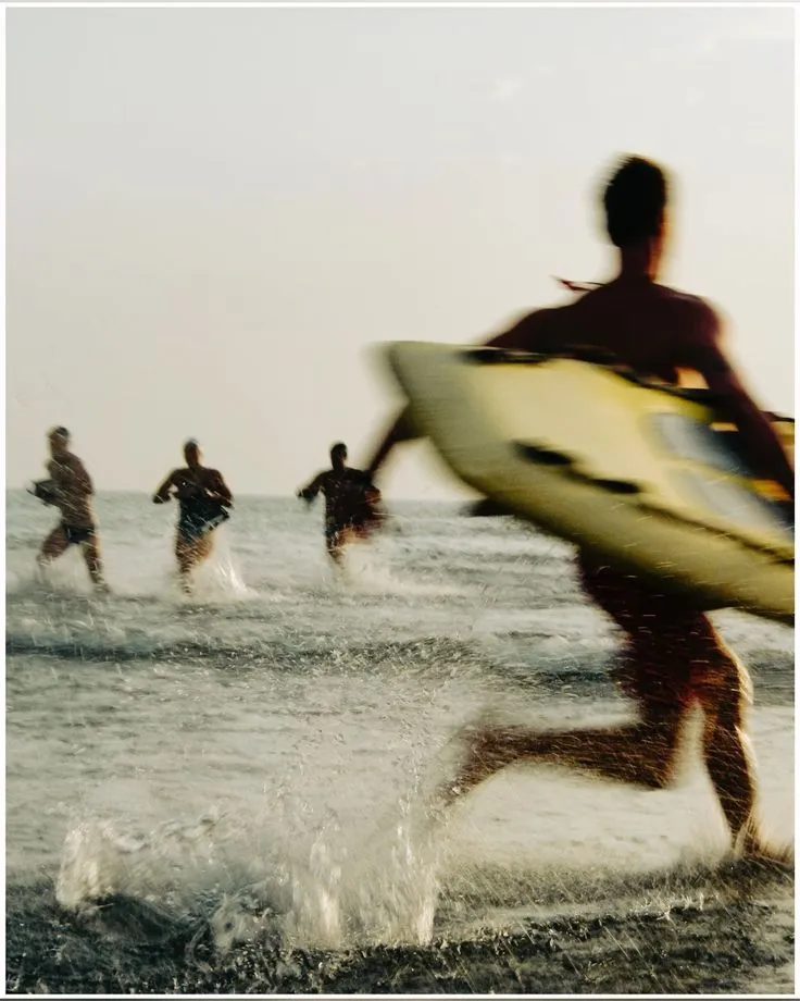 Surfers heading to the water